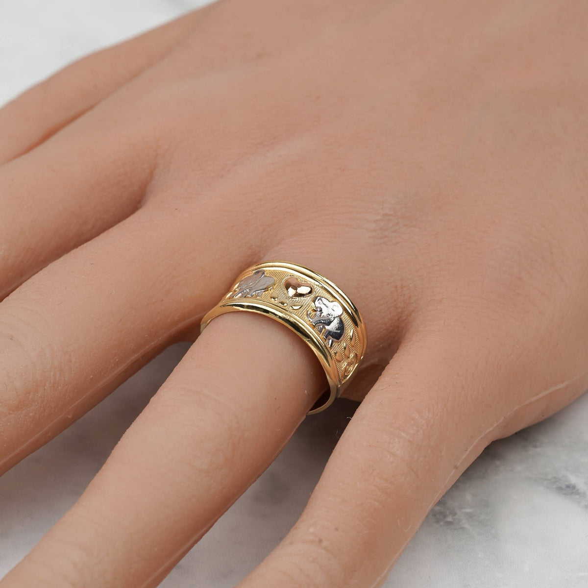 Close-up of a hand wearing the tricolor gold lucky elephant ring.