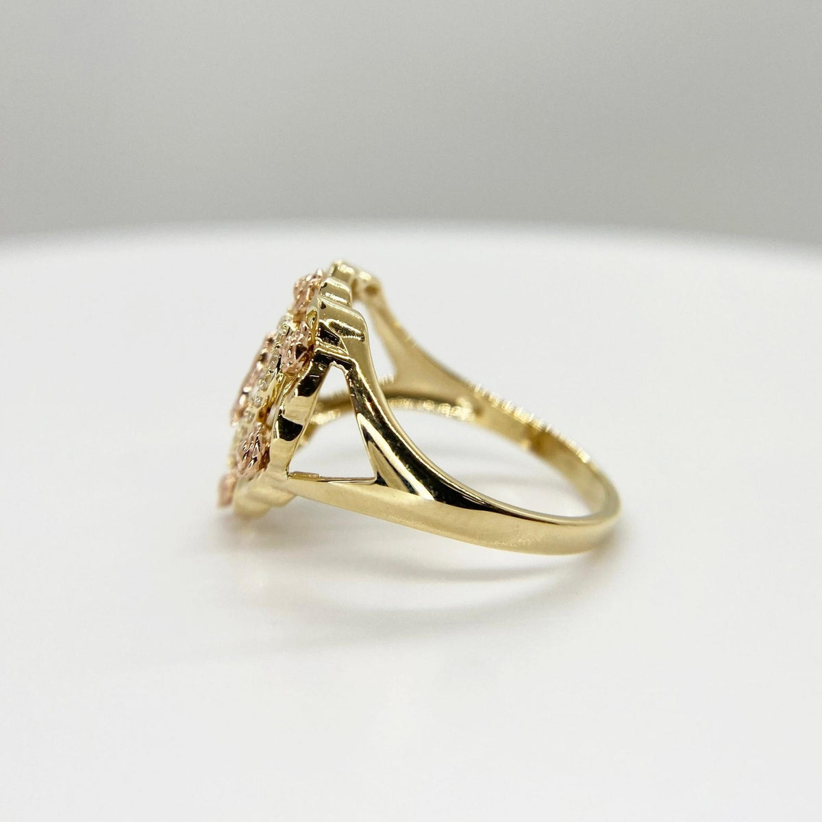 10k - 14k Gold ring with heart shape design side view on a light gray background