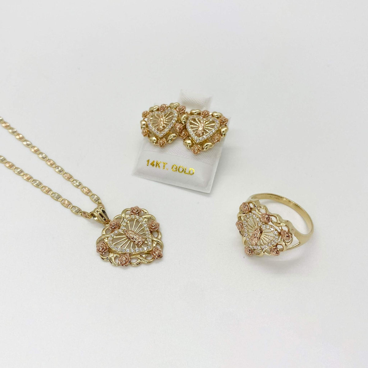 10k - 14k Gold jewelry set with necklace, earrings, and ring on a white background