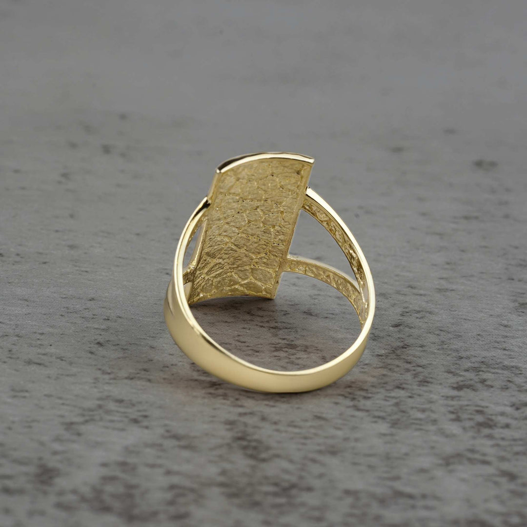 10k - 14k rectangle gold ring back view on a gray surface