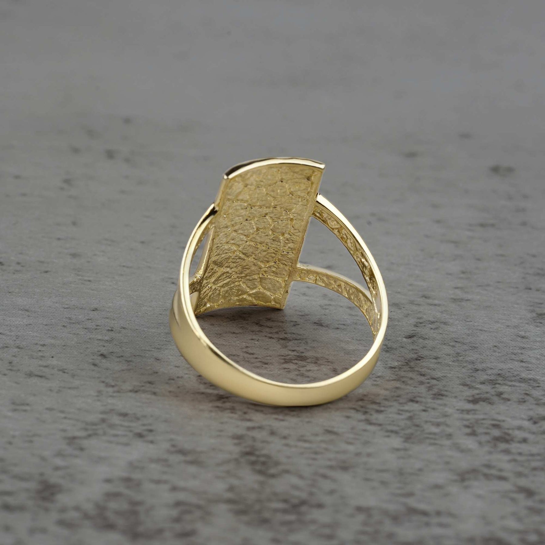 10k - 14k rectangle gold ring back view on a gray surface