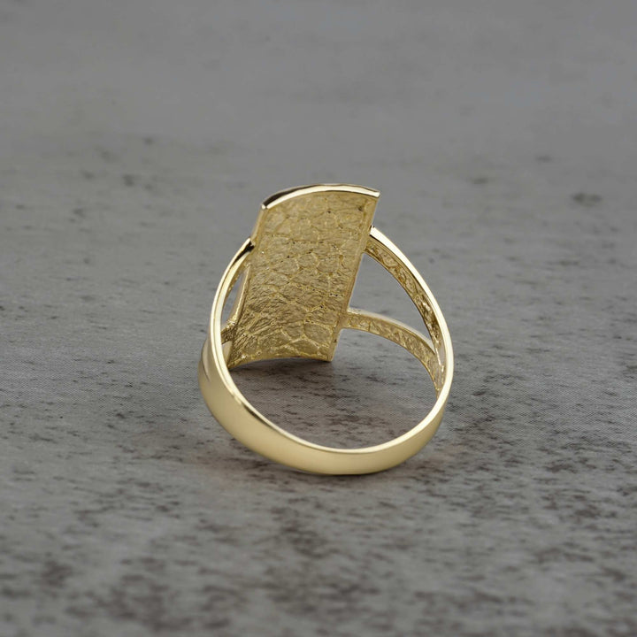 10k - 14k rectangle gold ring back view on a gray surface