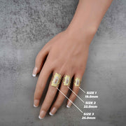 hand wearing three 10k - 14k gold rings with size measurements on a gray background