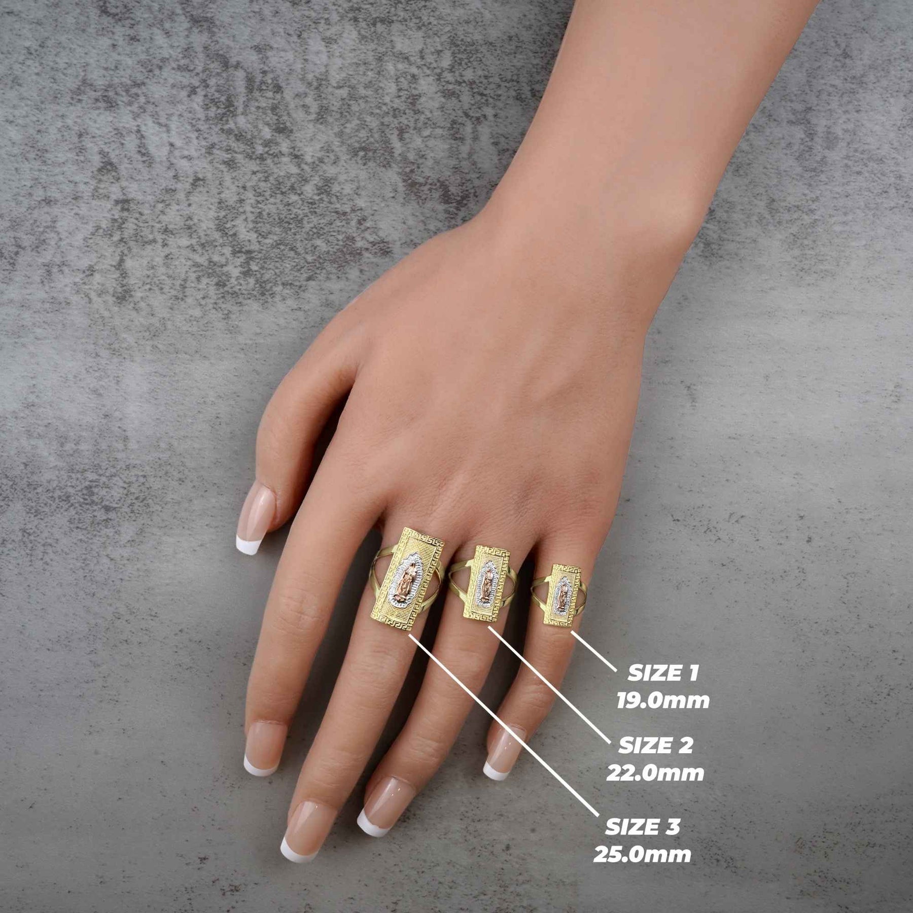 hand wearing three 10k - 14k gold rings with size measurements on a gray background