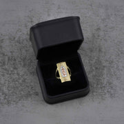 10k - 14k gold ring with a Virgin Mary design in a black jewelry box on a gray surface