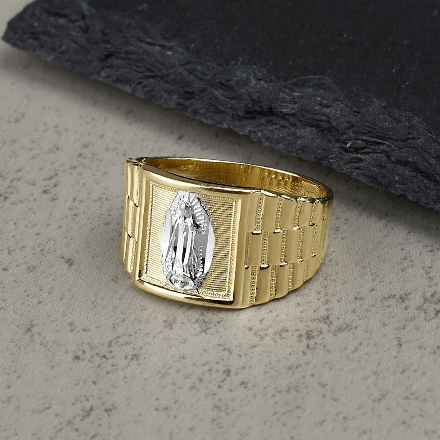 10k - 14k Gold Virgin Mary Rollie signet ring on a gray textured background.