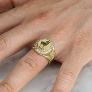 Lifestyle view of a gold Aries zodiac signet ring worn on a man's finger.