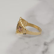 Side view of a tricolor gold Quinceañera ring on marble surface.