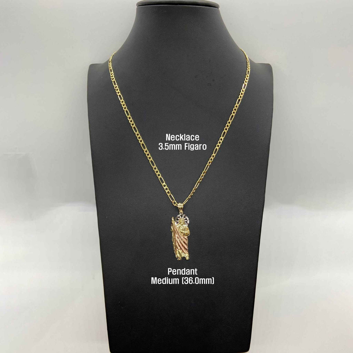 Medium San Judas pendant on 3.5mm Figaro chain displayed on black neck mannequin.