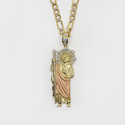Tri-color gold San Judas pendant necklace with CZ accents displayed on a gold figaro chain.