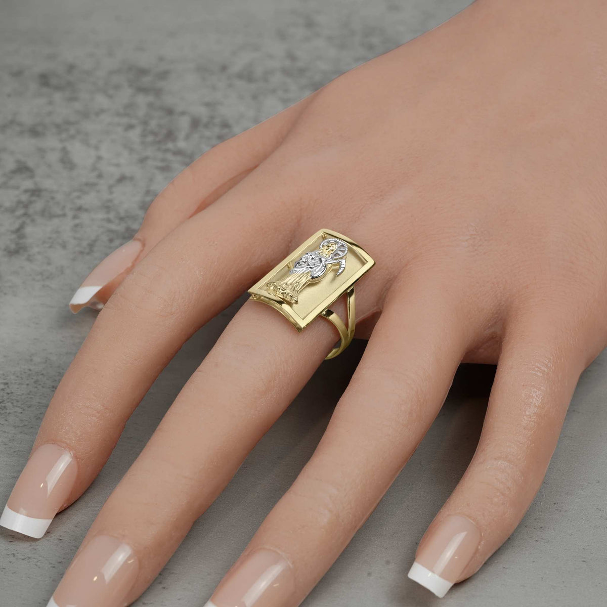 Model wearing a men's 10k two-tone gold rectangular Grim Reaper signet ring on finger.