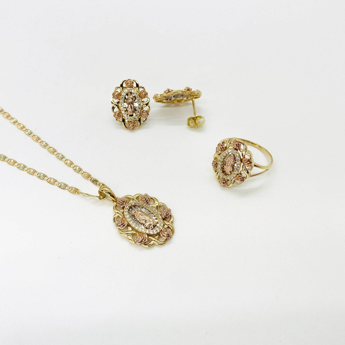 Gold Virgin Mary Guadalupe jewelry set including a pendant necklace, ring, and stud earrings.