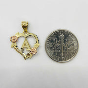 Two-tone gold heart initial charm with rose accents alongside a U.S. dime size comparison.
