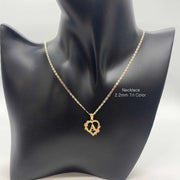 Gold heart initial pendant with letter A featured on a black mannequin display bust.