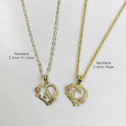 Two gold floral heart initial necklaces labeled by chain style on light background.