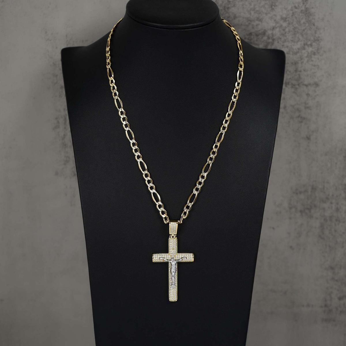 Two-tone gold Hermo iced crucifix pendant necklace displayed on a black jewelry mannequin bust.