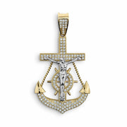 Gold anchor crucifix pendant with white gold Jesus figure and cubic zirconia on white background.