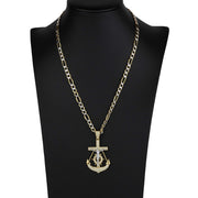 Gold anchor and crucifix pendant necklace displayed on a black mannequin bust.