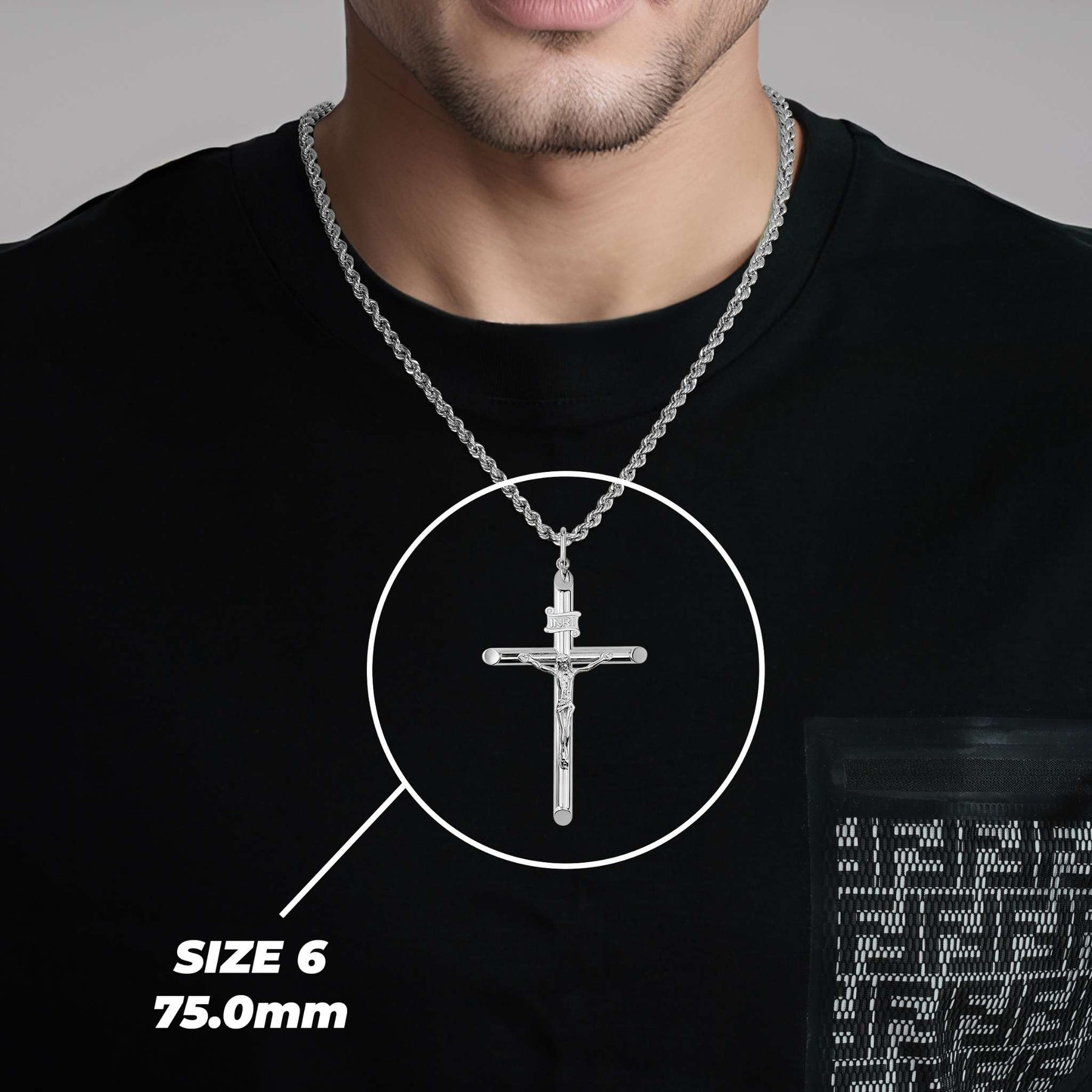 Man wearing a size 6 (75.0mm) white gold tubular INRI crucifix pendant on a black shirt.