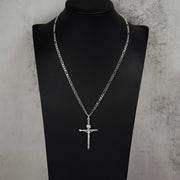 Classic 10k white gold tubular crucifix pendant and chain resting on a black display mannequin.