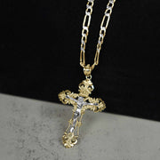 Two-tone gold and white gold INRI crucifix pendant on gold Figaro chain.