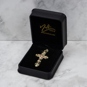 Two-tone gold crucifix pendant displayed inside an open black Nolters branded gift box.