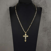 Gold chain necklace with a cross pendant displayed on a black mannequin.