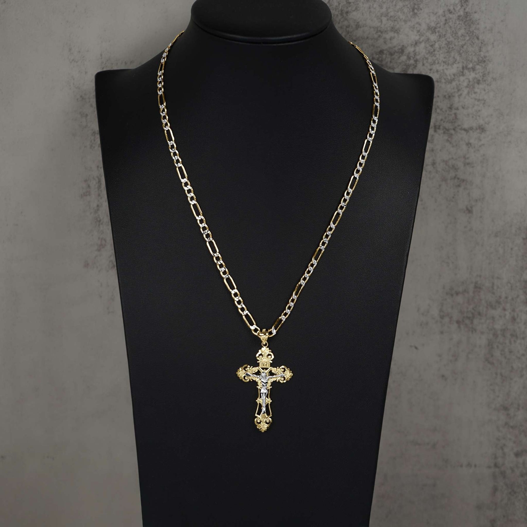 Gold chain necklace with a cross pendant displayed on a black mannequin.