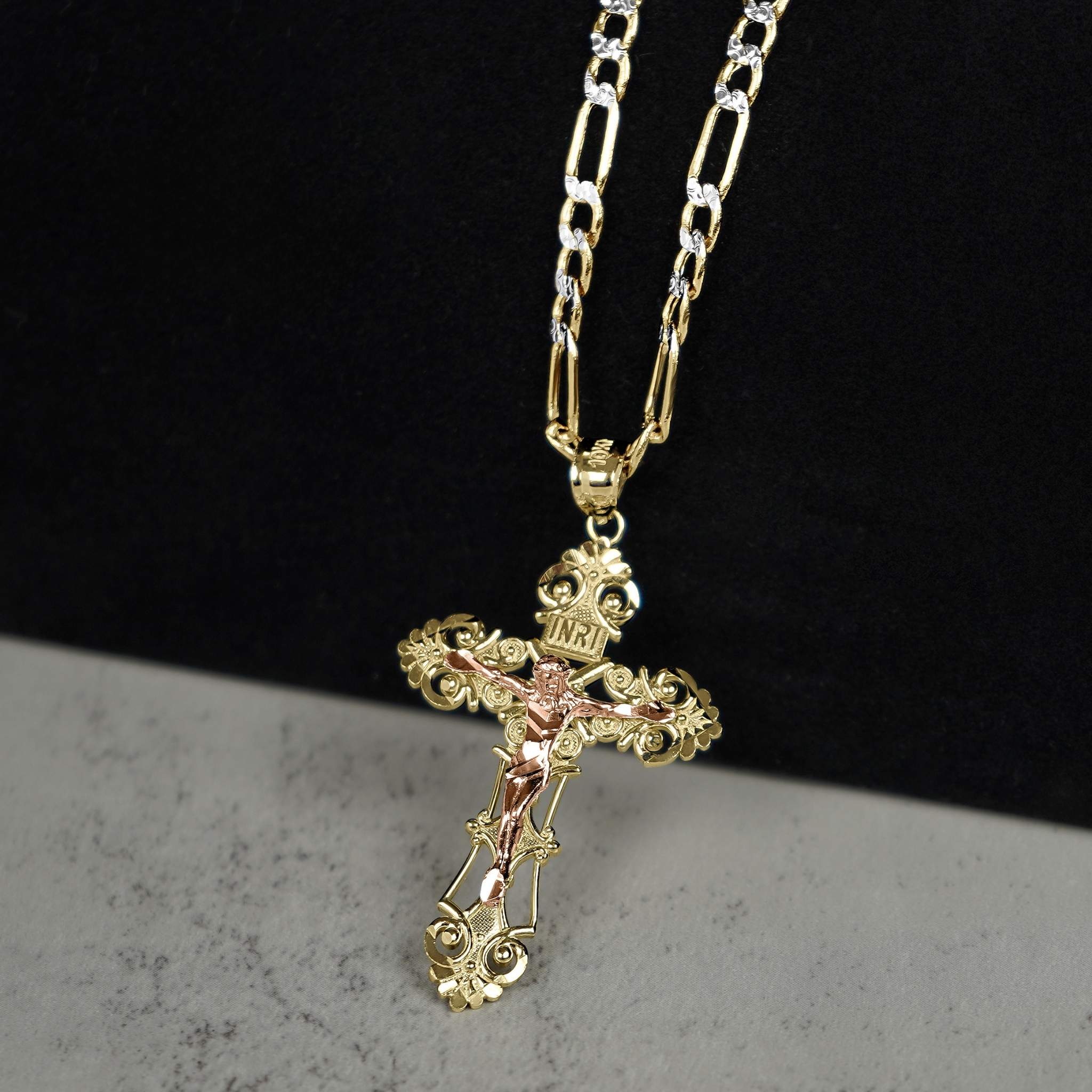 Product view of the two-tone crucifix pendant showcasing the INRI inscription and detailed corpus.