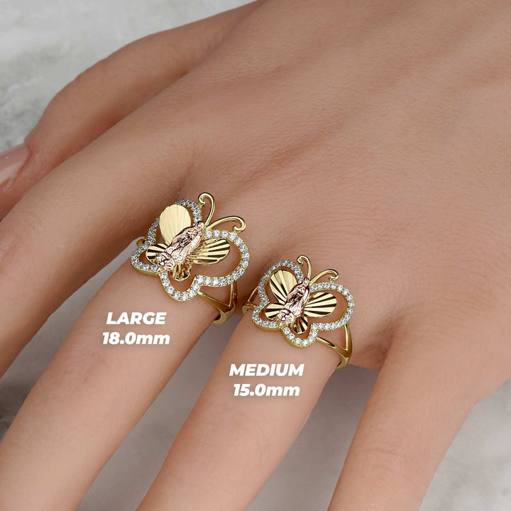 Large and medium gold butterfly rings on a hand with size measurement text.