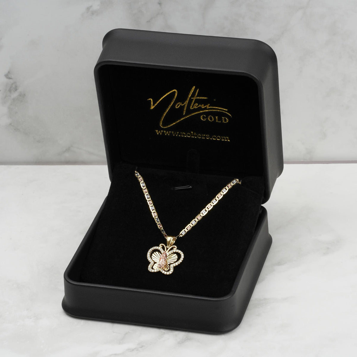 A model wearing a gold butterfly pendant necklace with a size 3 callout.