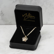 Gold Virgin Mary Guadalupe butterfly CZ pendant necklace displayed inside an open black jewelry box on marble.