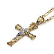 A two-tone gold crucifix pendant on a gold chain against a white background.