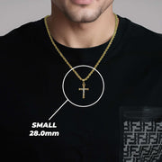 A man wearing a small gold cross pendant labeled small 28.0mm.