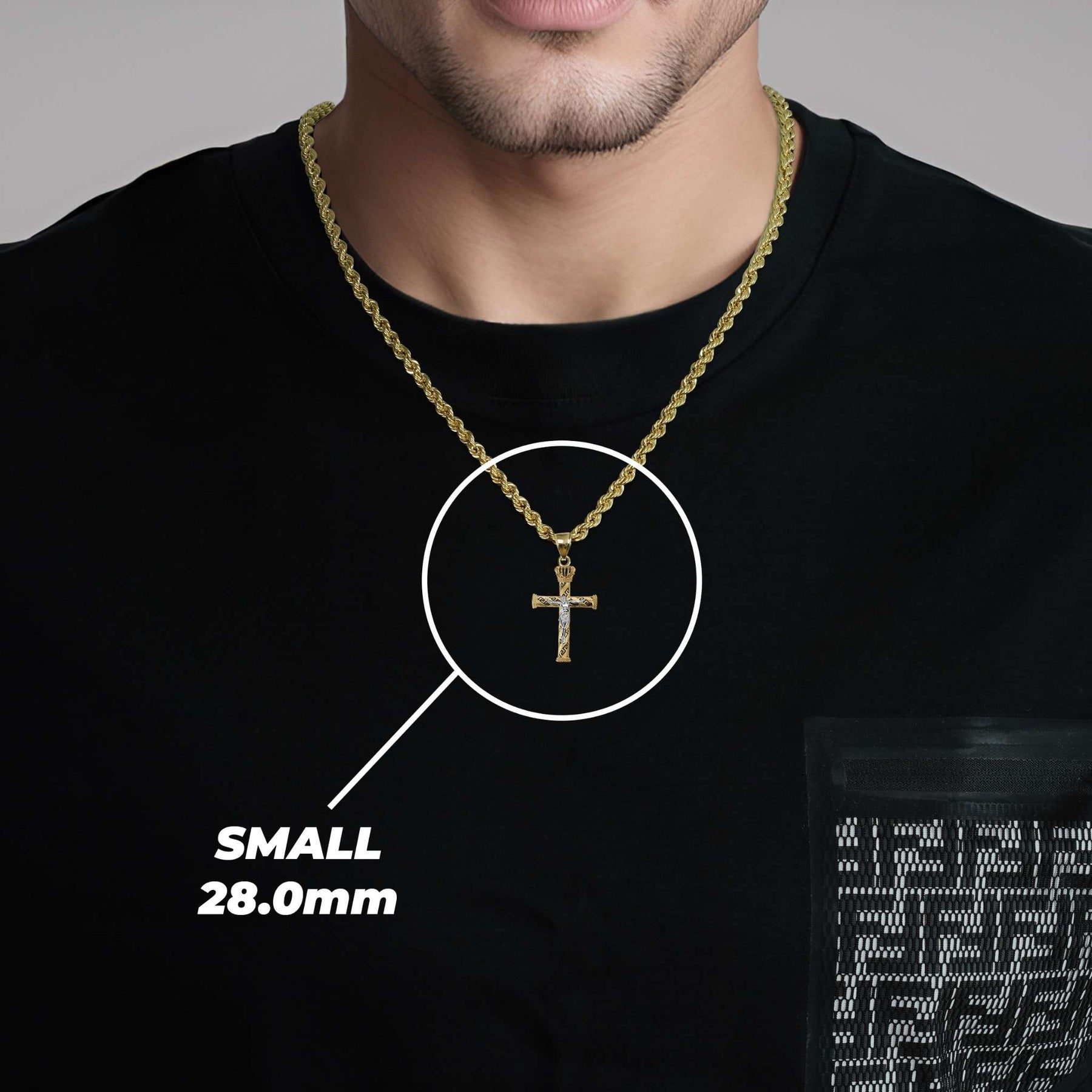 A man wearing a small gold cross pendant labeled small 28.0mm.