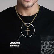 A man wearing a medium gold cross pendant labeled medium 38.0mm.