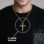 A man wearing an X Large gold crucifix pendant labeled X LARGE 60.0mm.