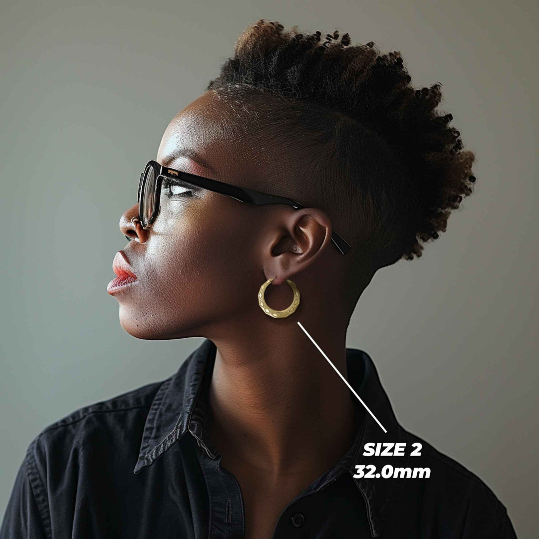 Model wearing Size 2 32.0mm textured gold rhombus hoop earrings for size reference.