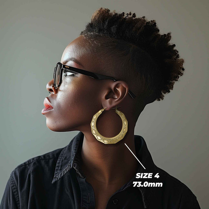 Model wearing Size 6 73.0mm textured gold rhombus hoop earrings for size reference.