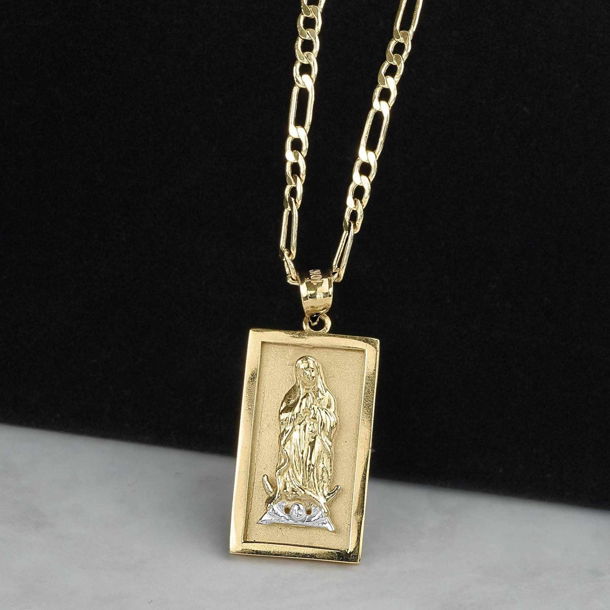 Rectangular two-tone gold Virgin Mary Guadalupe pendant on a classic Figaro chain.