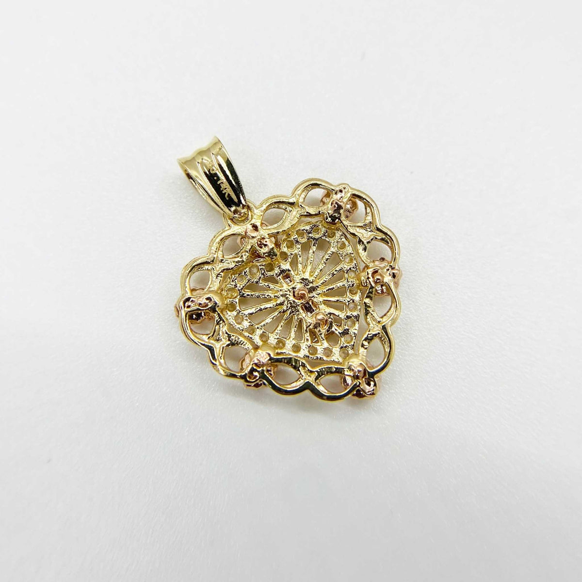Back view of gold filigree Virgin Mary heart pendant with textured mesh details.