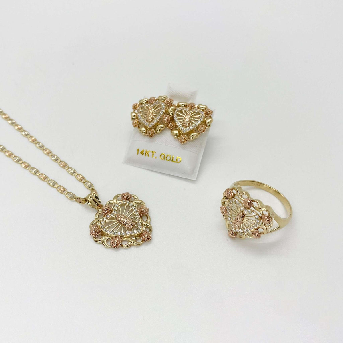 Matching Virgin Mary heart pendant necklace, stud earrings, and ring jewelry set in gold.