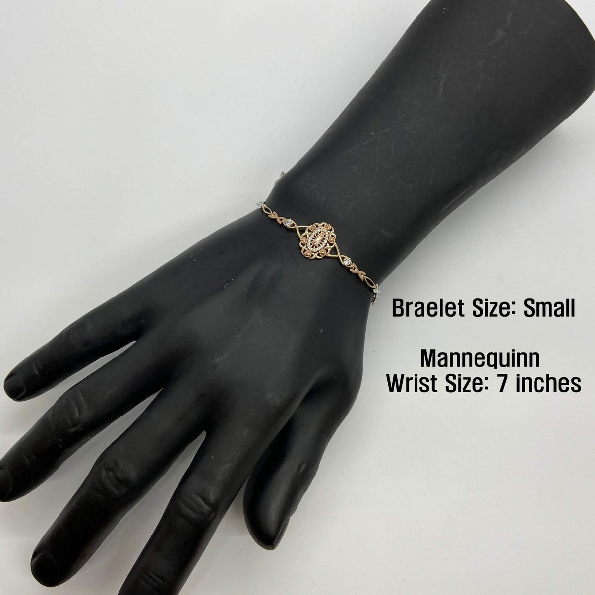 Small size tri-color gold Virgin Mary Guadalupe bracelet displayed on a black mannequin hand