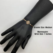 Medium size tri-color gold Virgin Mary Guadalupe bracelet displayed on a black mannequin hand.