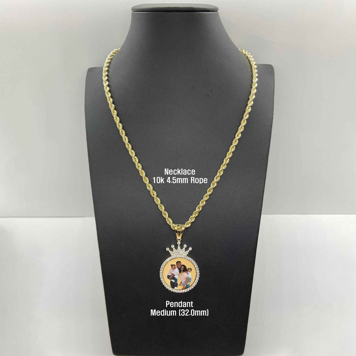 Medium gold crown picture pendant displayed on a black mannequin bust with rope chain.