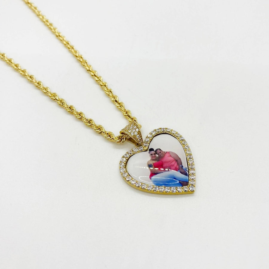 10k and 14k gold heart-shaped memorial picture pendant necklace with CZ border on rope chain.