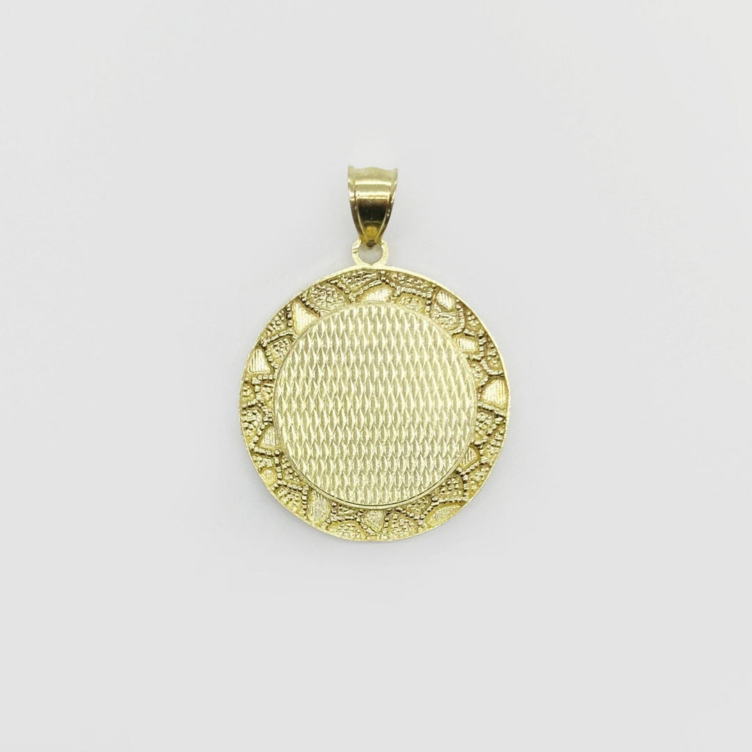 Round gold pendant with a textured crosshatch center and classic nugget-style border.