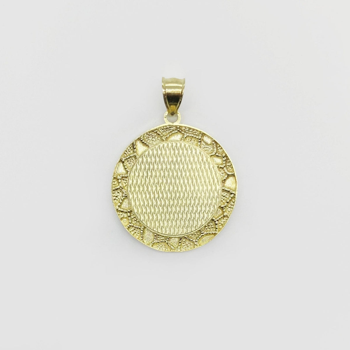Round gold pendant with a textured crosshatch center and classic nugget-style border.