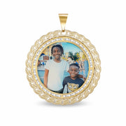 Round 10k gold memorial pendant featuring a custom photo of two children and a Cuban link border.