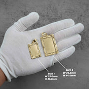 White-gloved hand displaying two different sized rectangular gold pendant frames with dimension guidelines.